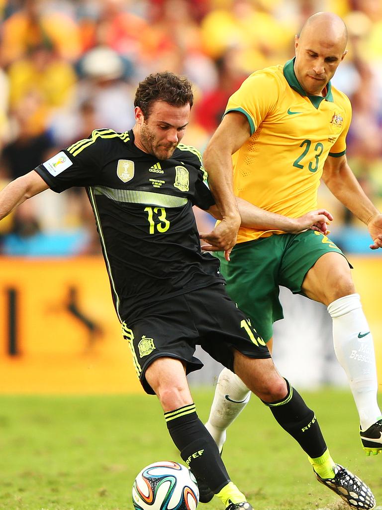 Mata against Mark Bresciano at the 2014 FIFA World Cup. Photo by Ian Walton/Getty Images