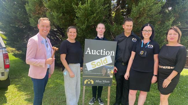 Auctioneer Jay Gibson, Sarah Cochrane, Alex Whaites, Julian Bryant, Allison Whaites and Sara Black celebrate an outstanding auction result in Tucabia after selling a property for $50,000 over the reserve.