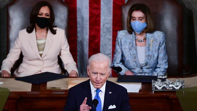 US President Joe Biden addresses a joint session of Congress as US Vice President Kamala Harris and US Speaker of the House Nancy Pelosi listen at the US Capitol in Washington.