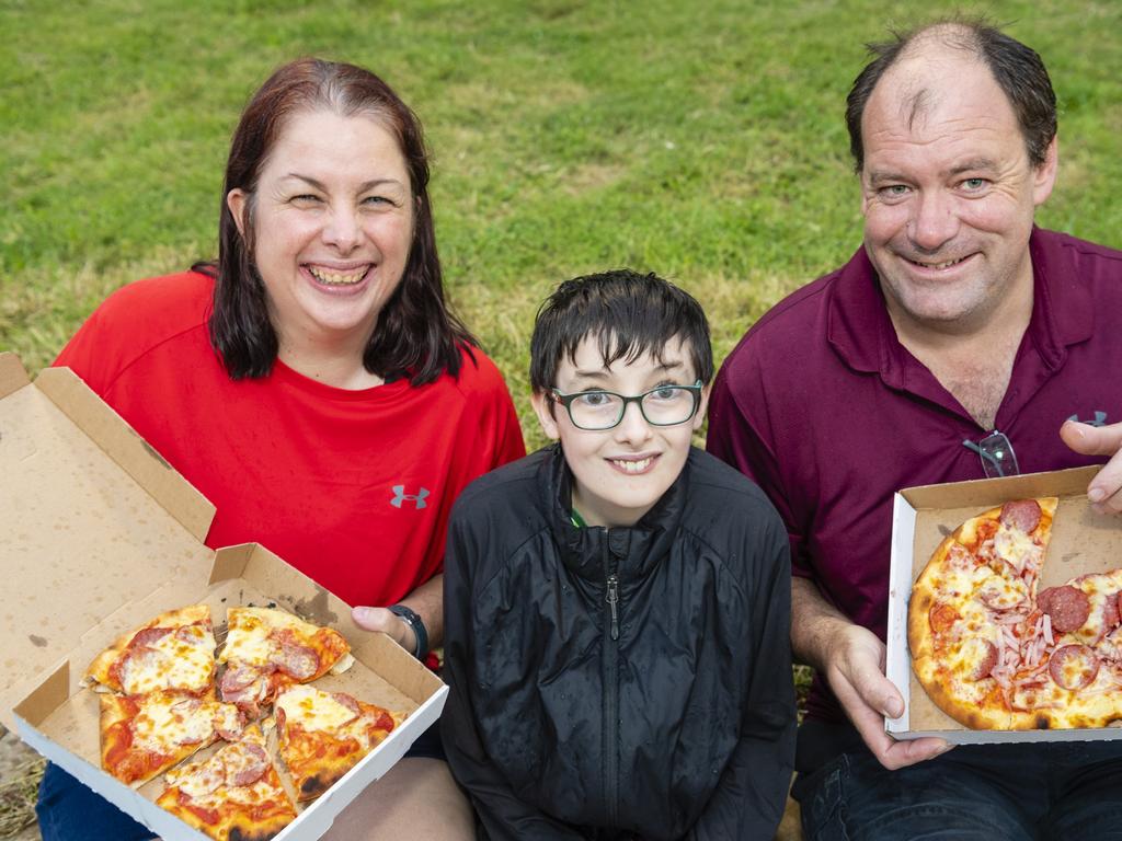 Enjoying pizza are (from left) Naomi, Liam and Jamie Dowe at the 2022 Toowoomba Royal Show, Friday, March 25, 2022. Picture: Kevin Farmer