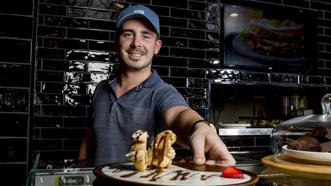 New Southport French restaurant Paris Brest owner Virgil Penalva with the signature sweet treat, a Paris brest. Picture: Jerad Williams