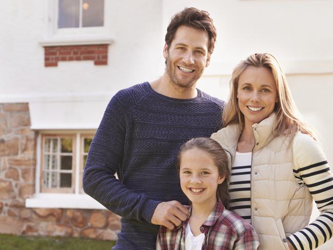 Happy family outside their home.Source: iStock