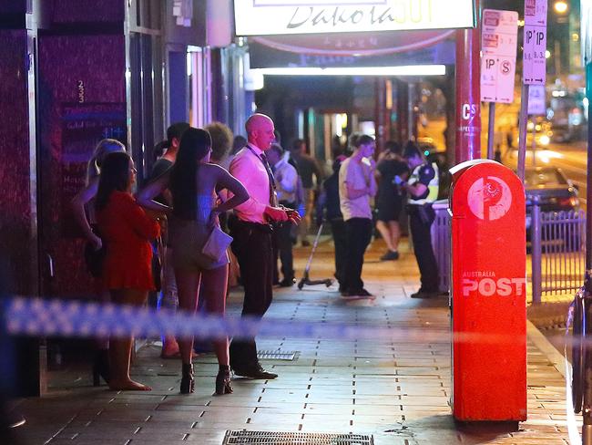 The aftermath: police speak to witnesses. Photo: Patrick Herve