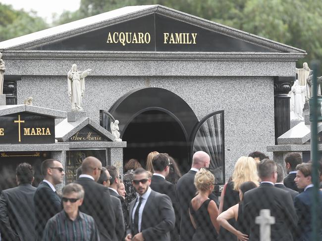 Mourners congregate at the Acquaro family tomb in Footscray during the funeral for Joe Acquaro. Picture: Jake Nowakowski