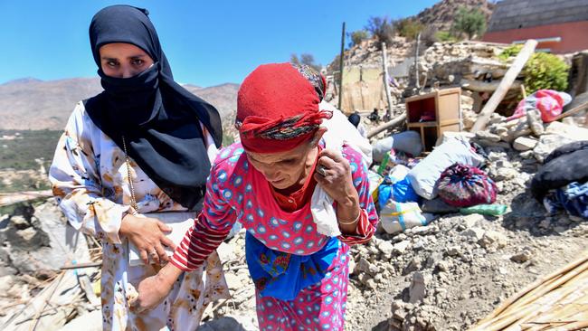 Women walk on the rubble of homes in Imoulas village in the Taroudant province, one of the most devastated in quake-hit Morocco. Picture: AFP