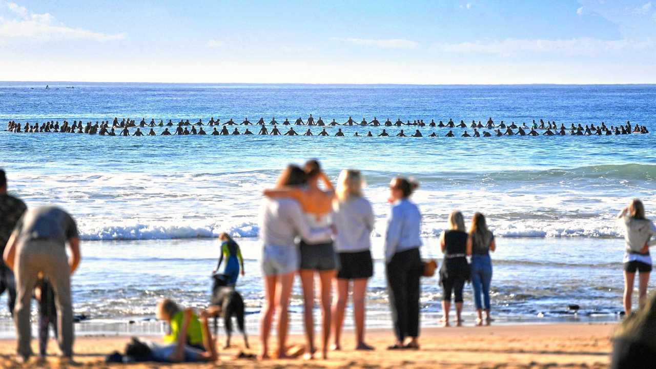 FAREWELL FOR A FRIEND: Hundreds gathered at Mudjimba Beach yesterday to paddle out in honour of Mike Daniell. Onlookers were touched as surfers formed a circle in the ocean for their friend. Picture: John McCutcheon