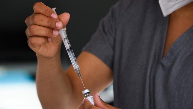 A physician assistant prepares a syringe with a dose of the Pfizer Covid-19 vaccine at the Weingart East Los Angeles YMCA this year. Picture: AFP