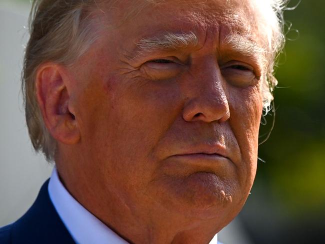 TOPSHOT - Former US President Donald Trump speaks to the media while departing a polling station after voting in the US midterm elections at Morton and Barbara Mandel Recreation Center in Palm Beach, Florida, on November 8, 2022. (Photo by Eva Marie UZCATEGUI / AFP)