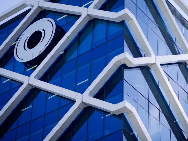 The Macquarie Group Ltd. logo is displayed on the facade of the Macquarie Group Building in Sydney, Australia, on Friday, April 27, 2012. Macquarie Group Ltd., Australia's largest investment bank, said it's relying on cost cuts to revive earnings after a slump in trading income and dealmaking dragged full-year net income to an eight-year low. Photographer: Ian Waldie/Bloomberg