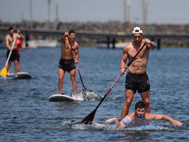 St Kilda players finish their training session with stand-up paddle boarding.