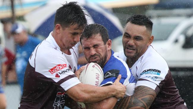 Matt Egan (left) makes a tackle against Tugun. Picture: Mike Batterham