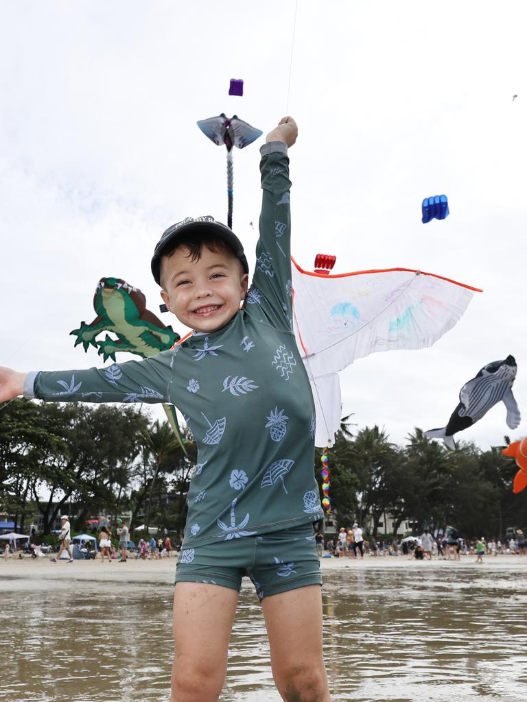 Bohdi Hook, 3, has fun flying a kite which is dwarfed by the huge kites flying above Four Mile Beach when the attended Port Douglas Carnivale's family beach day on Saturday. Picture: Brendan Radke