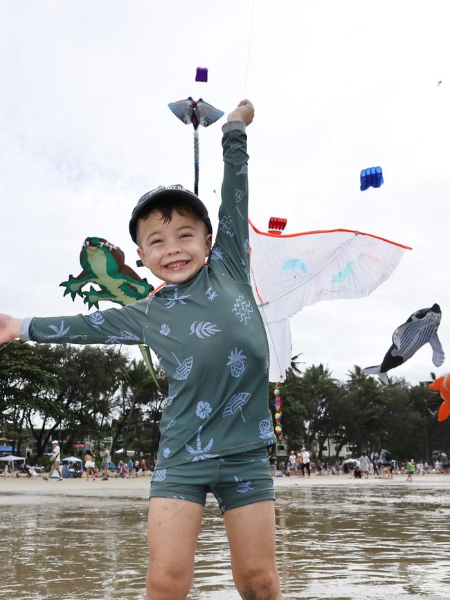 Bohdi Hook, 3, has fun flying a kite which is dwarfed by the huge kites flying above Four Mile Beach when the attended Port Douglas Carnivale's family beach day on Saturday. Picture: Brendan Radke