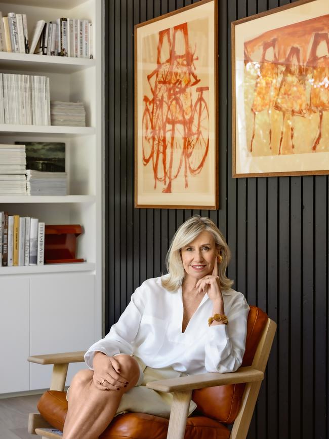 Oroton creative director Sophie Holt, sitting in a Getama Plank chair from Great Dane Furniture, with Britt Neech artwork (above left) and a vintage painting from her childhood, says heritage brands can come with a degree of baggage so you have to be prepared to act with courage. Picture: Derek Swalwell