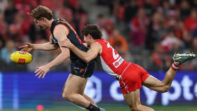 Tom Green is tackled by Errol Gulden. Picture: Mark Metcalfe/AFL Photos/via Getty Images