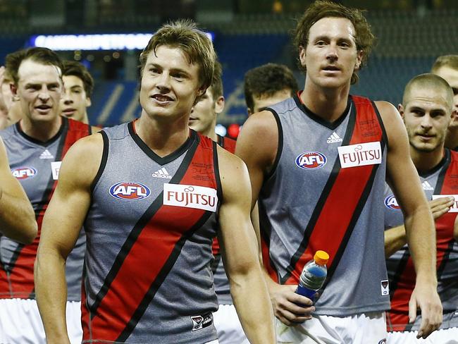 Essendon top-up players Clinton Jones and Mitch Brown lead the Bombers off after a NAB Challenge win.