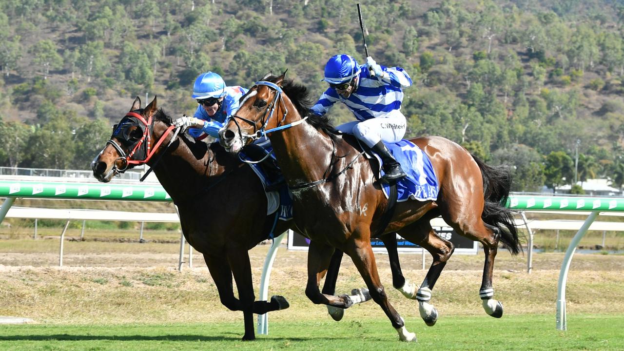 Lacey Morrison on Play Me Now (sky blue silks) drives down the inside to win the Ray White Townsville Open Handicap on Ladies Day at Cluden Park. Picture: Matthew Elkerton