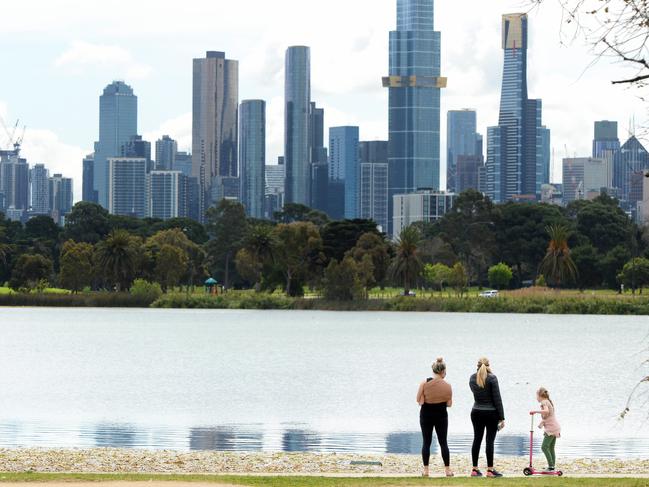 MELBOURNE, AUSTRALIA - NewsWire Photos OCTOBER 07, 2021: People walk around Albert Park Lake with the Melbourne city skyline in the distance. Picture: NCA NewsWire / Andrew Henshaw