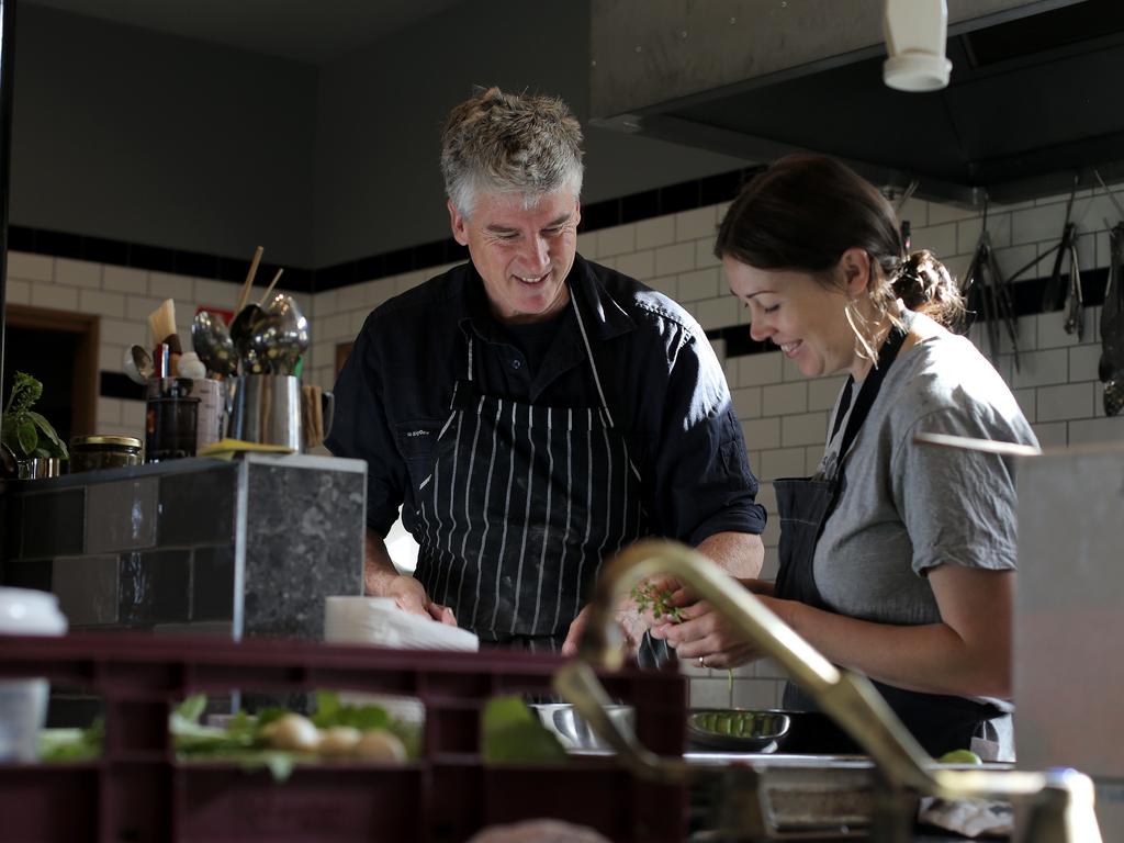 Matthew Evans works in the kitchen with staff member Seona Moss, preparing food for guests arriving at Fat Pig Farm in 2017. Picture: Luke Bowden