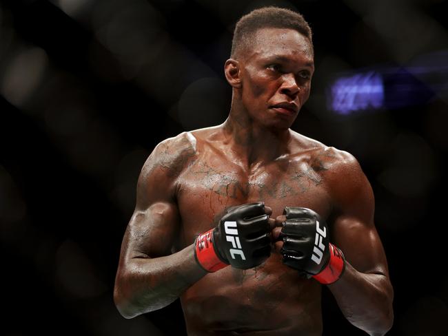 HOUSTON, TEXAS - FEBRUARY 12: Israel Adesanya of Nigeria looks on in his middleweight championship fight against Robert Whittaker of Australia during UFC 271 at Toyota Center on February 12, 2022 in Houston, Texas. (Photo by Carmen Mandato/Getty Images)