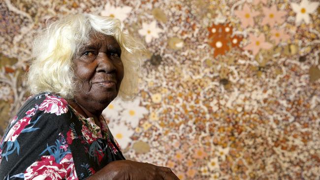 Mavis Ngallametta in 2018 with her painting, Swamp on the way to Obun. Picture: Anna Rogers