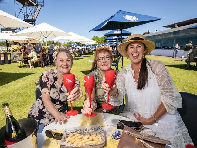 Rhonda Evans, Judy Stone and Leanne Du Plessi enjoy champagne at a trackside table. Picture: Jason Edwards