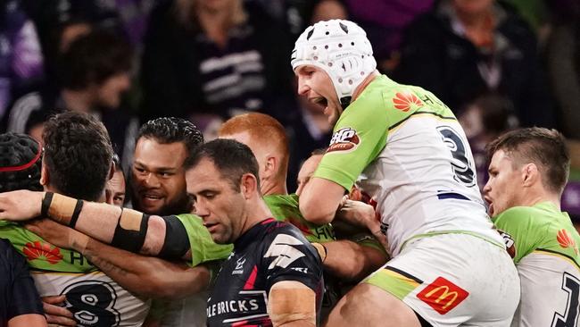 Josh Papalii of the Raiders is congratulated by his teammates after scoring the match winning try as Cameron Smith of the Storm looks on during the Round 22 NRL match between the Melbourne Storm and the Canberra Raiders at AAMI Park in Melbourne, Saturday, August 17, 2019. (AAP Image/Scott Barbour) NO ARCHIVING, EDITORIAL USE ONLY