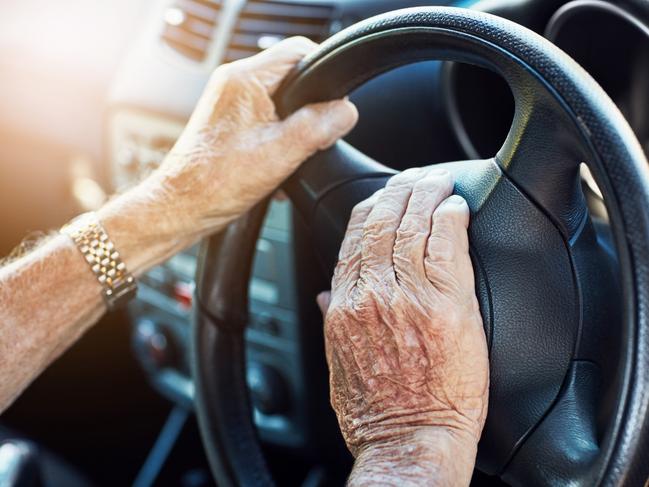 Closeup of an unrecognizable senior man's hands on the steering wheel of his car