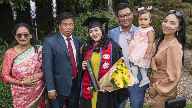 Bachelor of Nursing graduate is congratulated by family members (from left) Bijay Laxmi Kayastha, Krishna Bhakta Kayastha, Kiran Kayastha, Yuvragi Kayastha and Sushila Shrestha at a UniSQ graduation ceremony at Empire Theatres, Tuesday, February 13, 2024. Picture: Kevin Farmer