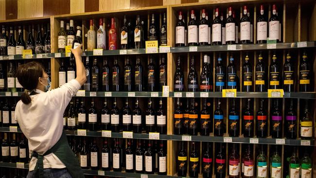 An employee in a Beijing wine store. Picture: AFP