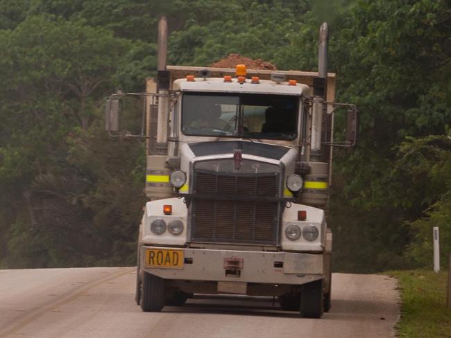 Christmas Island Phosphates trucks pass each other as they move to and from Phosphate Hill on Christmas Island, Territory of Christmas Island, Friday, Aug. 16, 2013. Phosphate mining, once the main area of economic activity, recommenced in 1991, mining the stockpile of the mineral.  (AAP Image/John Pryke) NO ARCHIVING