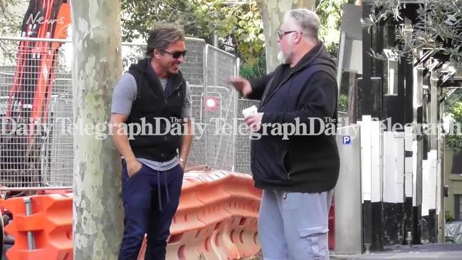 John Ibrahim and Kyle Sandilands laugh after police raid