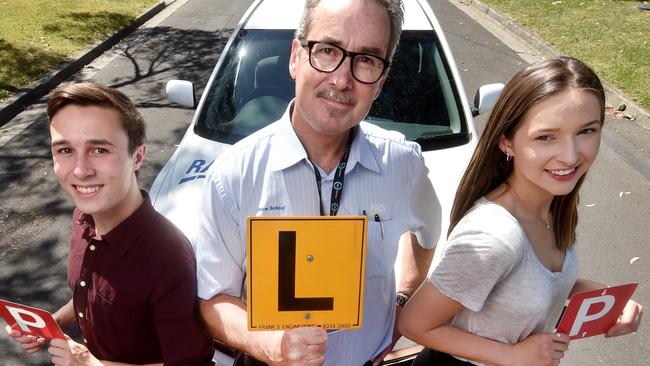 Daniel Bin, 18, and Chloe Wood, 18, with driving Instructor, Michael Waters. Picture: Jay Town.