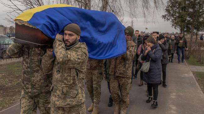 Ukrainian soldiers carry the coffin of late Ukrainian serviceman Andriy Katanenko, 39, who was killed near Avdiivka, which has fallen to the Russians. Picture: AFP