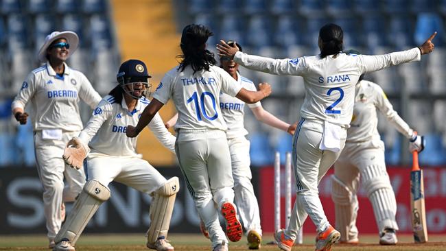 India's players celebrate after the dismissal of Australia's Alana King during the final day of the women's Test cricket match between India and Australia at the Wankhede Stadium in Mumbai on December 24, 2023. (Photo by Indranil MUKHERJEE / AFP) / -- IMAGE RESTRICTED TO EDITORIAL USE – STRICTLY NO COMMERCIAL USE --