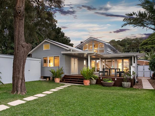 The five-bedroom weatherboard at Narrabeen has a north-to-rear lake frontage.
