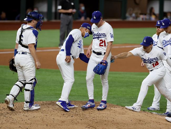 ARLINGTON, TEXAS - OCTOBER 12: Dave Roberts #30 of the Los Angeles Dodgers pulls Walker Buehler #21 during the sixth inning against the Atlanta Braves in Game One of the National League Championship Series at Globe Life Field on October 12, 2020 in Arlington, Texas. (Photo by Tom Pennington/Getty Images)