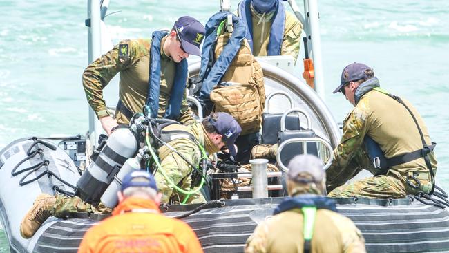 ADF divers work on recovering a World War 2 era UXO from Darwin Harbour at the site of the proposed ship lift. Picture: Glenn Campbell