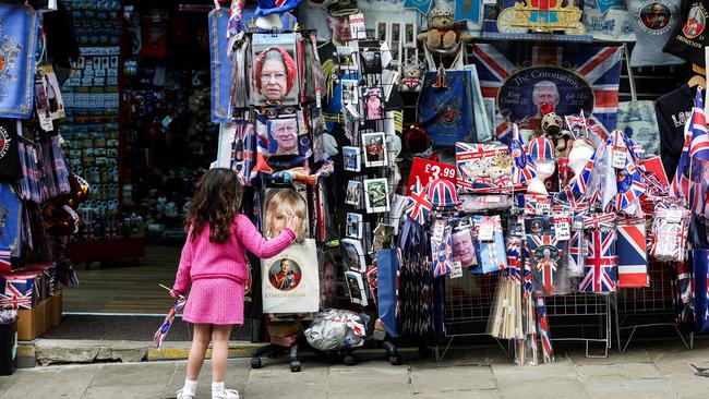 A child looks at a merchandise shop selling royals souvenirs, in Windsor, on May 2, 2023, ahead of the coronation ceremony of Charles III and his wife, Camilla, as King and Queen of the United Kingdom and Commonwealth Realm nations, on May 6, 2023. (Photo by Adrian DENNIS / AFP)