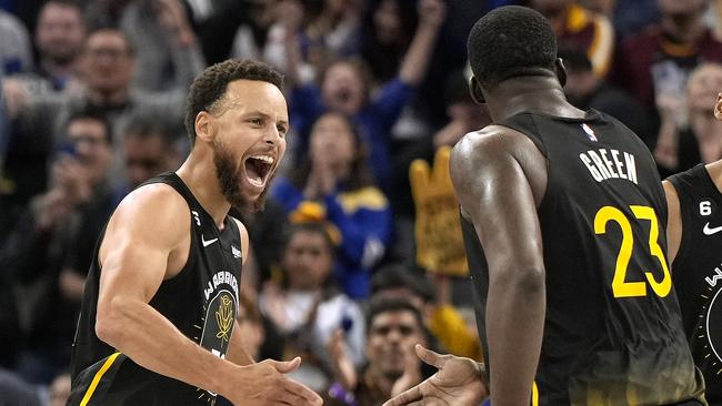 SAN FRANCISCO, CALIFORNIA - NOVEMBER 11: Stephen Curry #30 and Draymond Green #23 of the Golden State Warriors after Curry made a three-point shot against the Cleveland Cavaliers late in the fourth quarter of an NBA basketball game at Chase Center on November 11, 2022 in San Francisco, California. NOTE TO USER: User expressly acknowledges and agrees that, by downloading and or using this photograph, User is consenting to the terms and conditions of the Getty Images License Agreement. (Photo by Thearon W. Henderson/Getty Images)