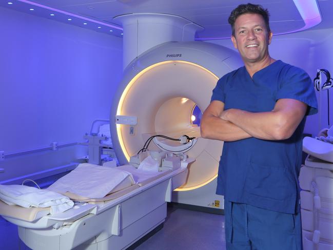 Dr Hal Rice is a neurointerventional radiologist who hosted a massive conference last year. Hal at his Southport practice with an MRI machine. Picture Glenn Hampson