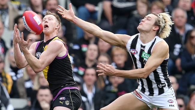 Jack Riewoldt beats a desperate Darcy Moore in a marking contest. Picture: Michael Klein