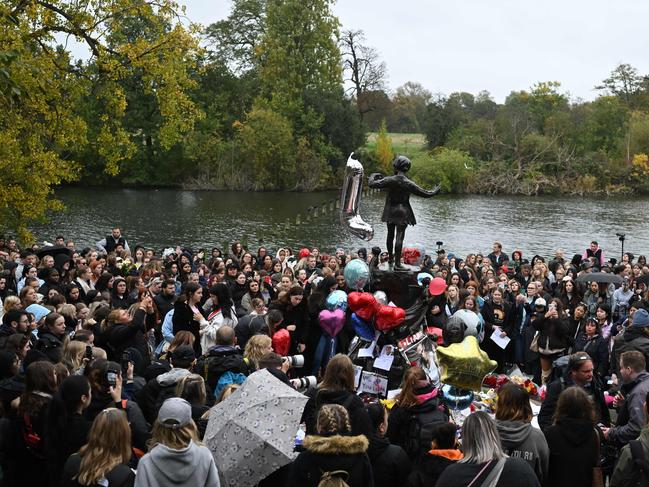 London: Fans of former One Direction singer Liam Payne gather with balloons and flowers beside the Peter Pan statue in Kensington Gardens, adjacent to Hyde Park. Picture: AFP