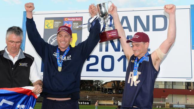 Rosebud coach Nick Jewell and captain Ryan Spooner hoist the 2015 premiership trophy. Picture: Andrew Henshaw