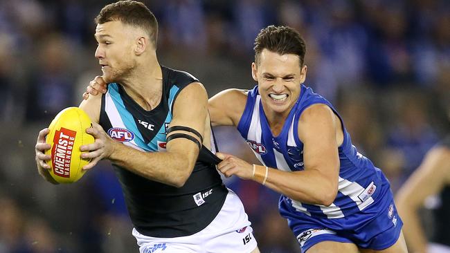 Robbie Gray tries to break the tackle of Ben Jacobs. Picture: Michael Klein