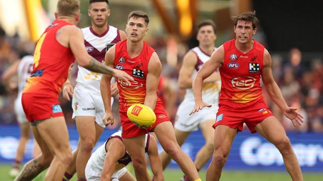 Connor Budarick gets a handball away as the Suns came up short at home. Picture: Chris Hyde/Getty Images