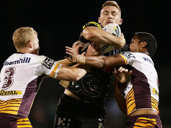 Bryce Cartwright is tackled by Jack Reed and Anthony Milford.