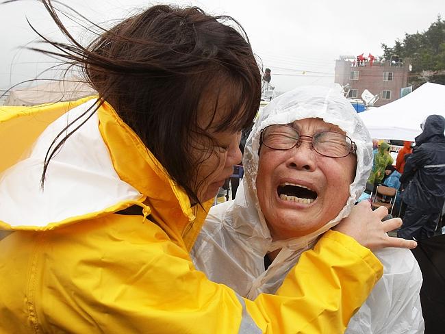 In total shock ... a relative weeps as she waits for missing passengers of a sunken ferry at Jindo port. Picture: Chung Sung-Jun.