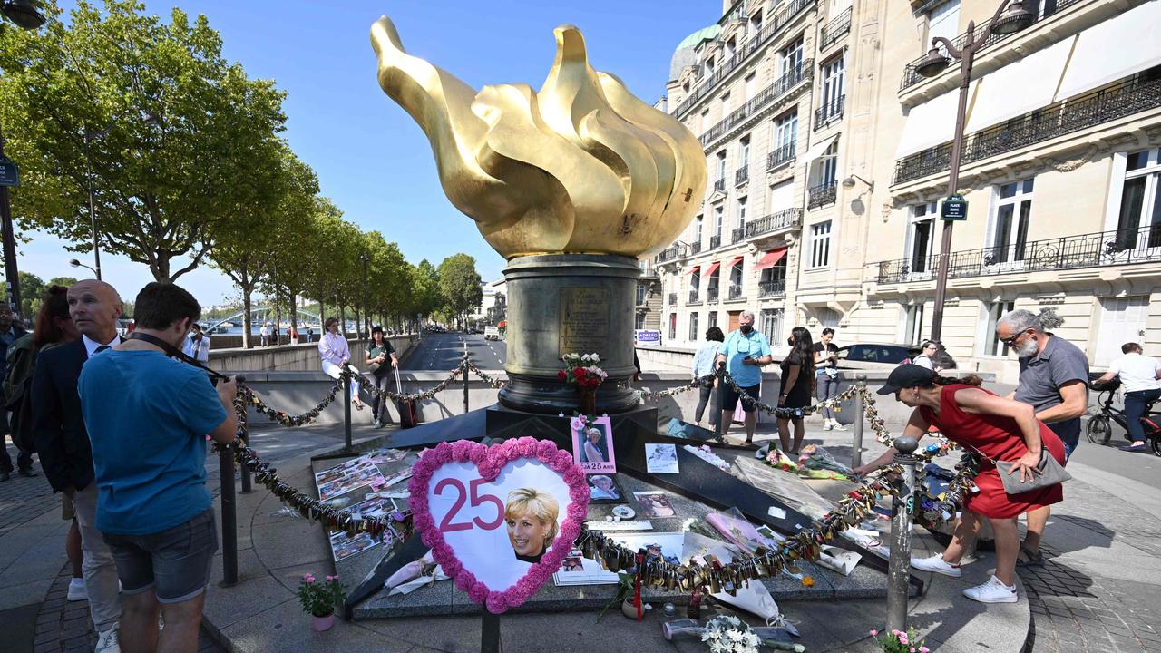 People pay tribute at the Flamme de la Liberte – Diana’s unofficial Paris memorial – 25 years after her death. Picture: Emmanuel Dunand/AFP