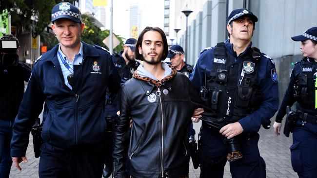 Environmental activist Eric Herbert is arrested during an Extinction Rebellion protest in the central business district of Brisbane, Wednesday, July 17, 2019. (AAP Image/Dave Hunt)